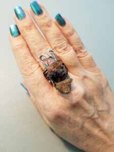 Tracy's Hand Wearing a Handcrafted Garnet and Amber Ring She Made