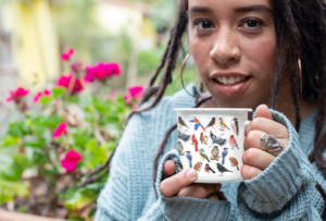 Young Woman Holding Tracy's Vintage Birds Design - Enamel Camping Mug