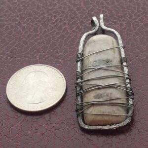An Annealed Steel and White Stone Handcrafted Pendant